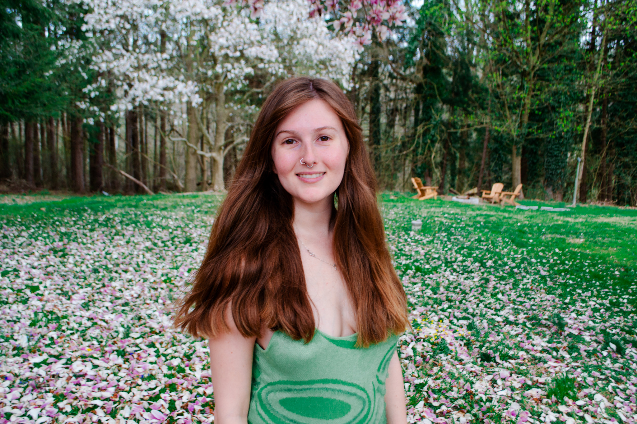 Kayley Sexton, founder of Nouveau Élan, standing in a flowering garden